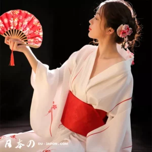 Femme en kimono blanc et rouge, élégante avec un ventilateur, charme traditionnel japonais.