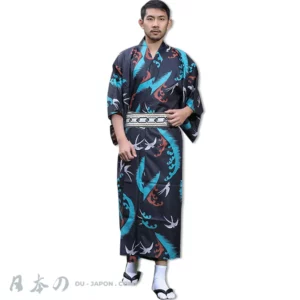 Homme en kimono noir avec motifs turquoise et rouge, ceinture obi élégante.